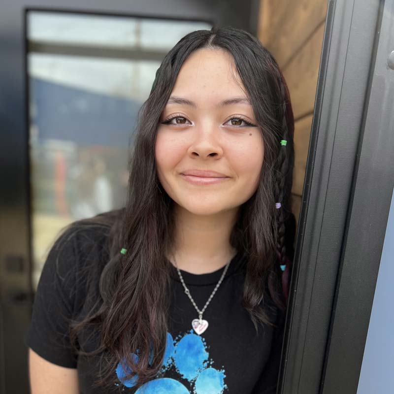 Photo of Emily leaning against a doorway